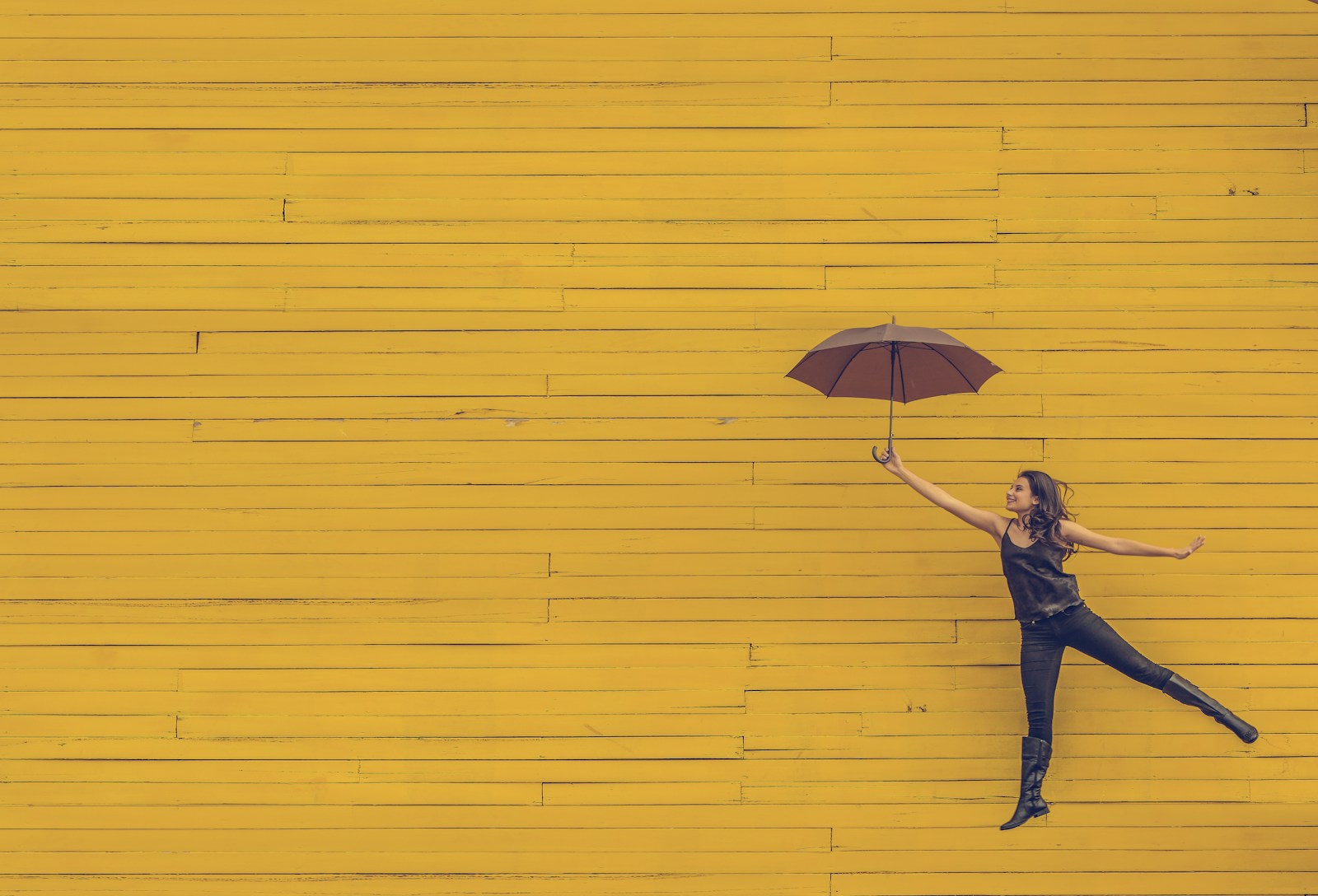 Photo by Edu Lauton woman holding brown umbrella